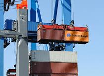 011_93_2386 Zwei 20 Fuß Standardcontainer (TEU = twenty-foot Equivalent Unit) werden mit einem Transport von der Containerkatze an Land gebracht - darunter sind auf dem Deck des Schiffs 40 Fuss Container (FEU) gestapelt.