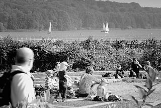 3054 Wiese am Ufer des Ratzeburger Sees in Ratzeburg - Kinderspielplatz, einige Segelboote auf dem Wasser - Schwarz - Weiss Fotografie.